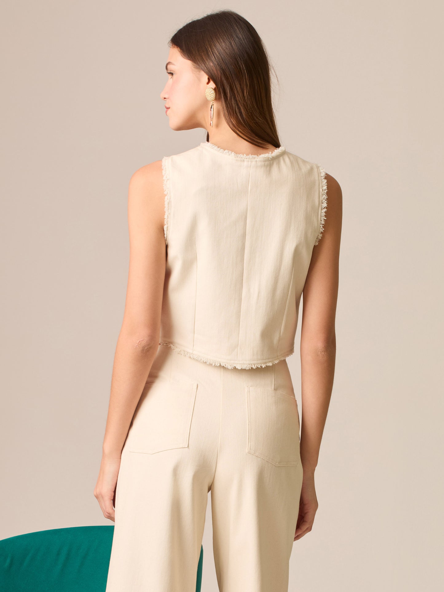 Blusa cropped sin mangas, escote redondo y botonadura frontal; bordes deshilachados y silueta entallada que realza la cintura—ideal para coordinar con tiro alto.
Detalles:
Color: Sand
Material: 98% Algodón 2% Elastomero
Cuidado: Lavar a mano con jabón suave, por separado.No dejar en remojo. Planchar a temperatura alta.