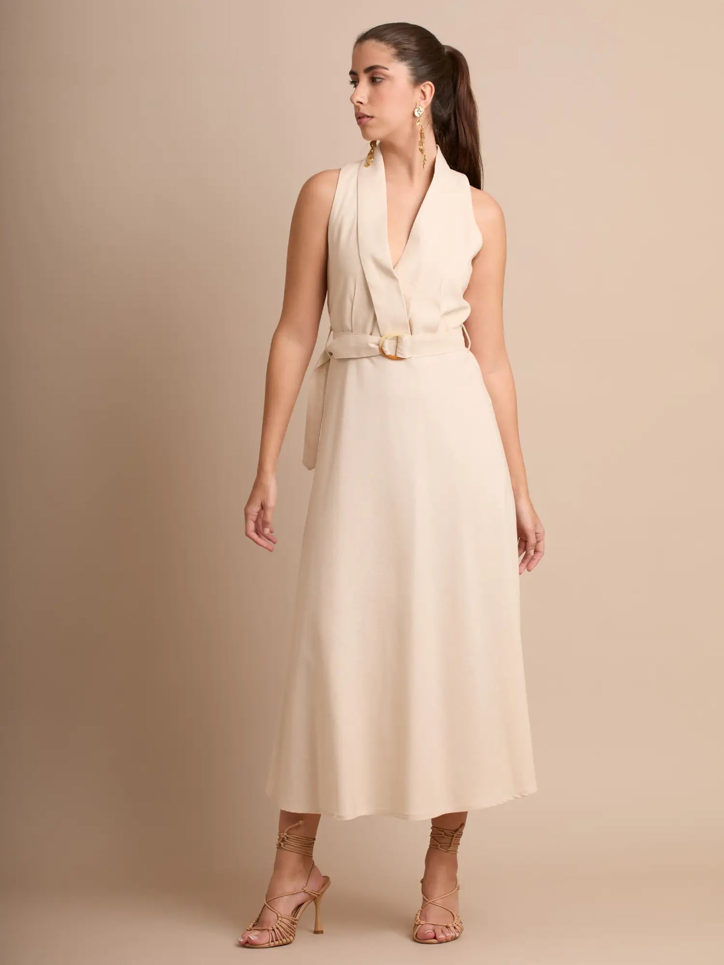 Un diseño sofisticado que combina un cuello tipo solapa con una falda midi de caída suave. Su cinturón con hebilla crea una silueta definida y femenina. Perfecto para eventos formales o looks minimalistas con estilo.