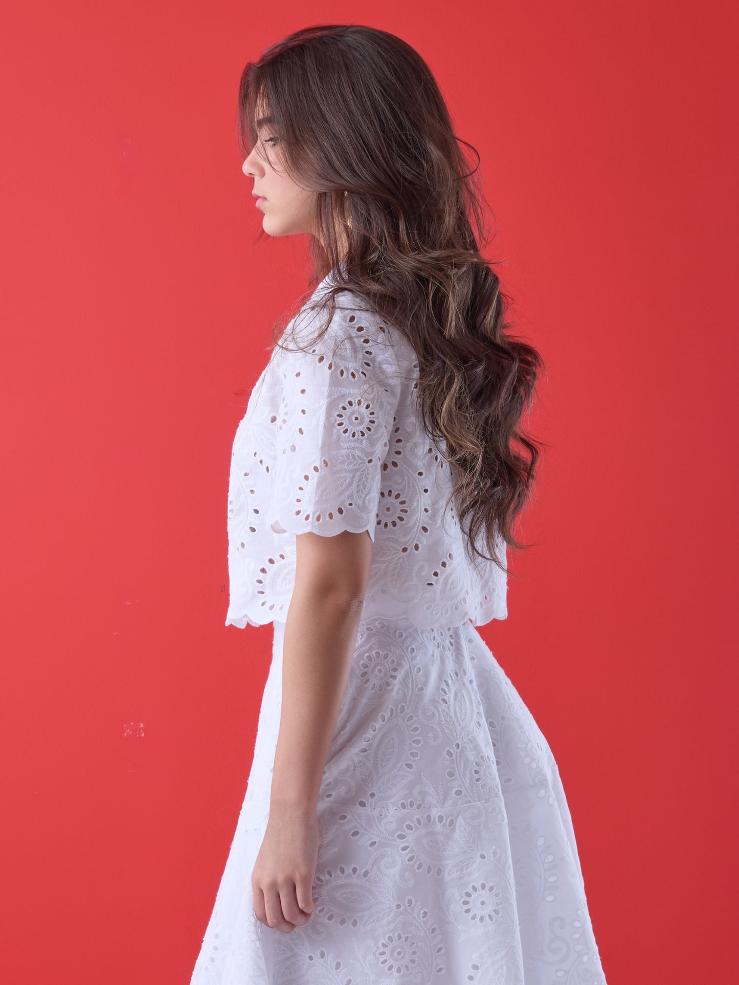 Con un diseño delicado y femenino, esta blusa corta presenta bordado calado en todo su contorno, aportando textura y un aire artesanal. El cuello camisero, la silueta relajada y las mangas cortas estructuradas la convierten en una prenda ideal para looks frescos y elegantes. Perfecta para combinar con faldas de talle alto o pantalones sutiles en ocasiones de día con un estilo impecable.