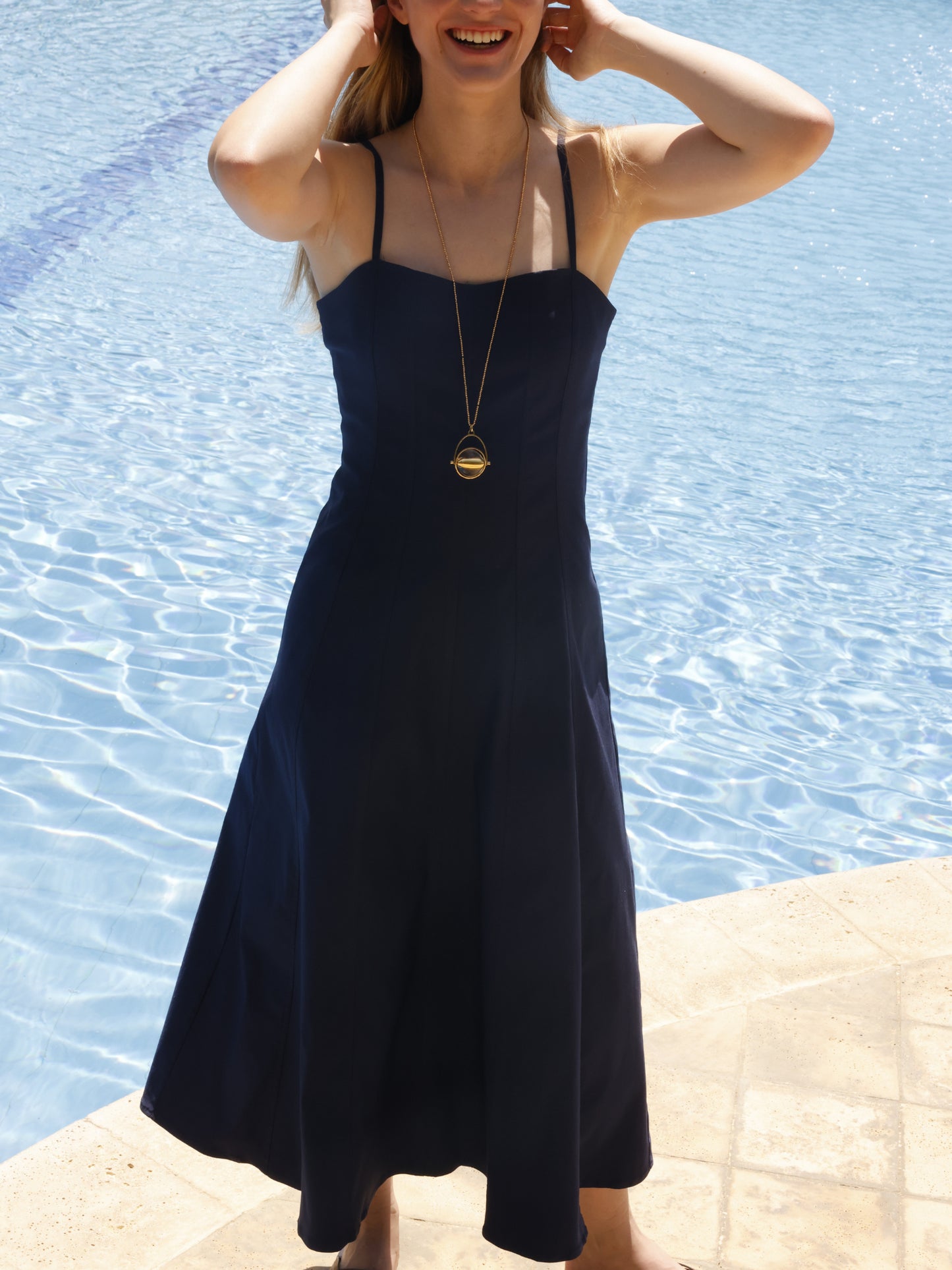 La prenda está entallada en la parte superior para realzar la silueta, mientras que la falda se abre ligeramente hacia abajo, dando libertad de movimiento y un efecto fluido. Su confección sin adornos excesivos resalta su estilo minimalista, ideal para adaptarse tanto a un look casual junto a la piscina como a un conjunto más sofisticado con los accesorios adecuados
Detalles:
Color: Navy
Material: 77% Rayon 20% Nylon 35 Spandex